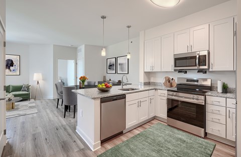 A kitchen with a large island and a dining area.