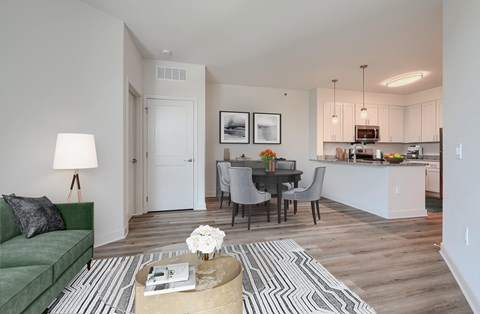 A living room with a green couch and a coffee table.