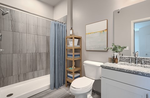 A bathroom with a toilet, sink, and shower.