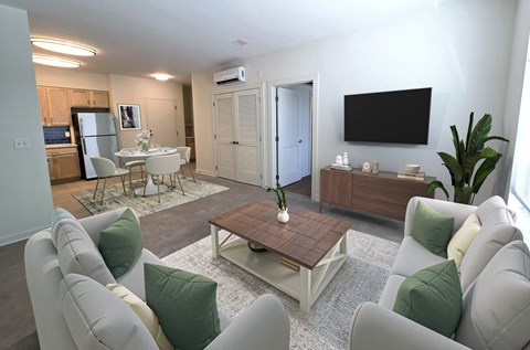 A living room with a grey couch and a wooden coffee table.