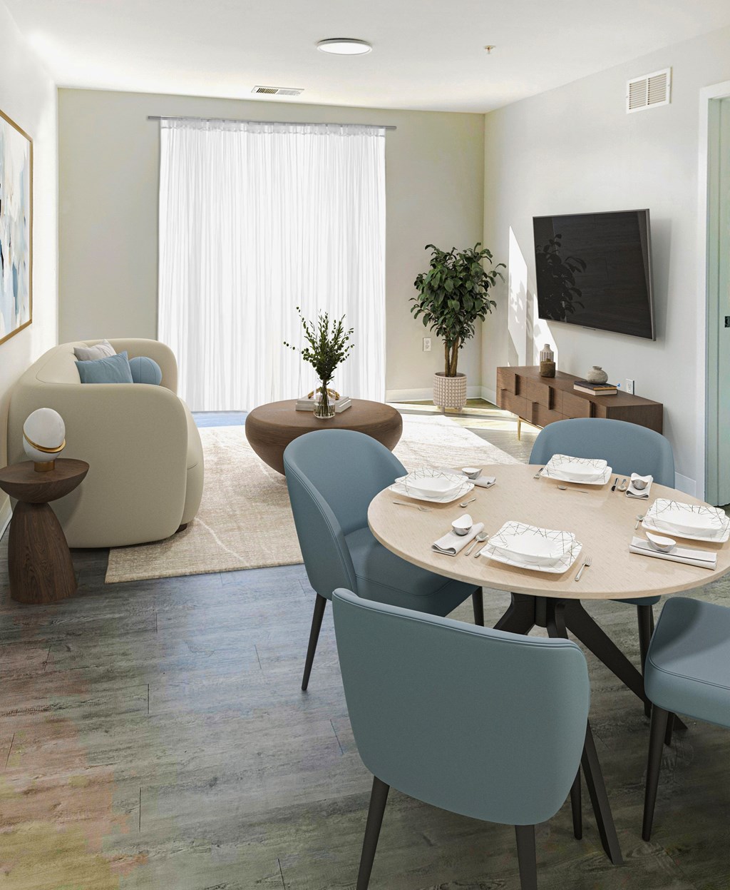 A modern dining room with a round table and chairs.