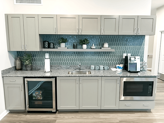 a kitchen with white cabinets and a counter top and a sink