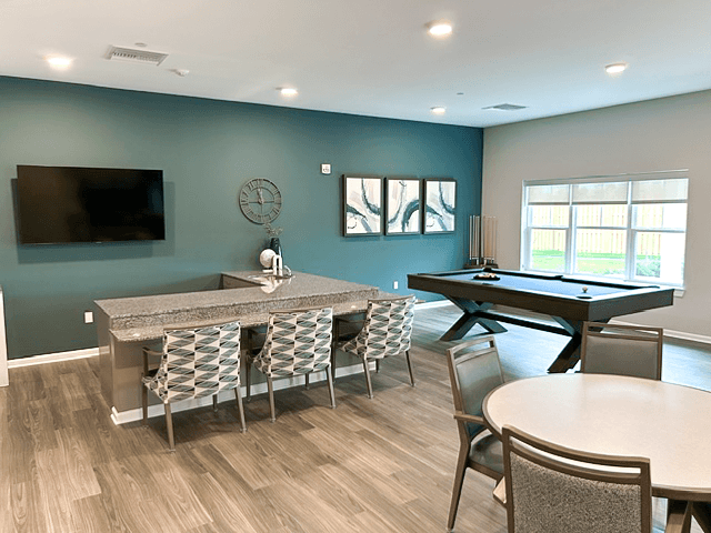 a game room with a pool table and a tv