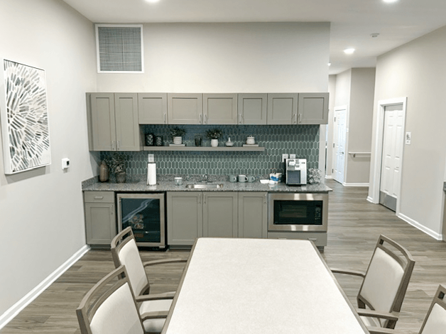a kitchen and dining room with a table and chairs