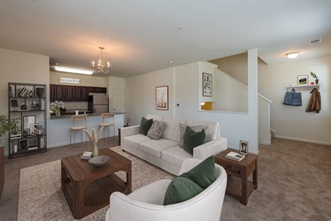 A living room with a white couch and a coffee table.
