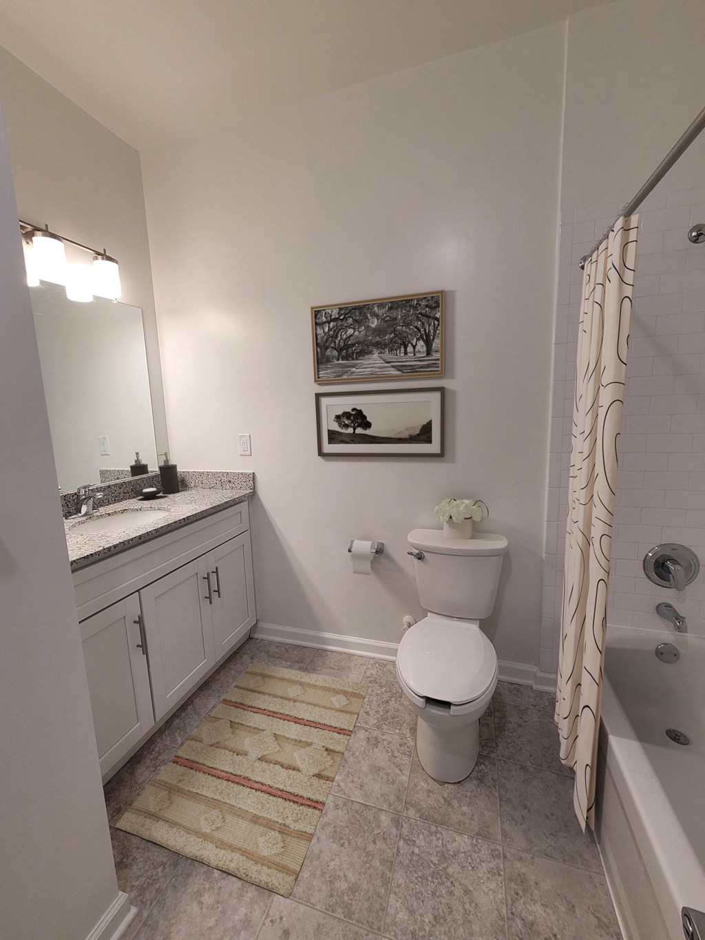 a bathroom with a toilet and a sink and a shower