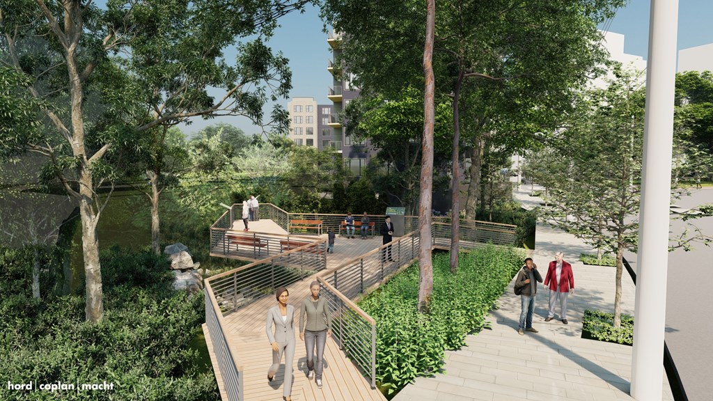 A group of people are walking on a wooden bridge in a park.