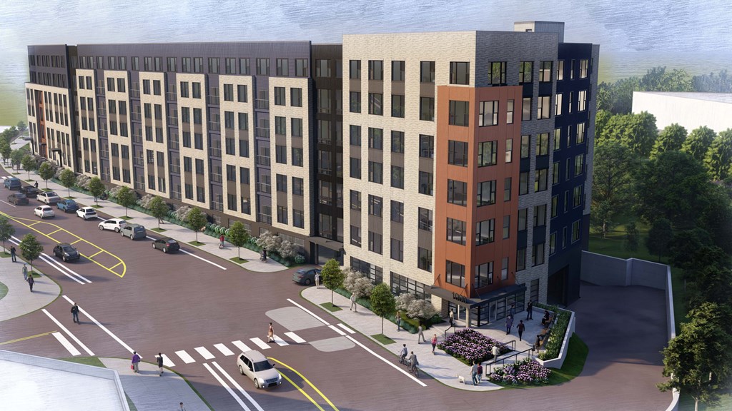 A modern building with a parking lot in front of it.