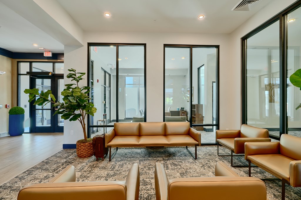 Now leasing senior 1-bedrooms in Baltimore, MD. A room with a brown sofa and a rug.