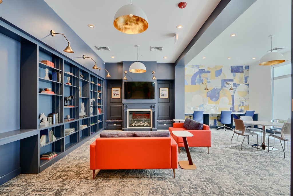 Now leasing senior 1-bedrooms in Baltimore, MD. A living room with a fireplace and a bookshelf.