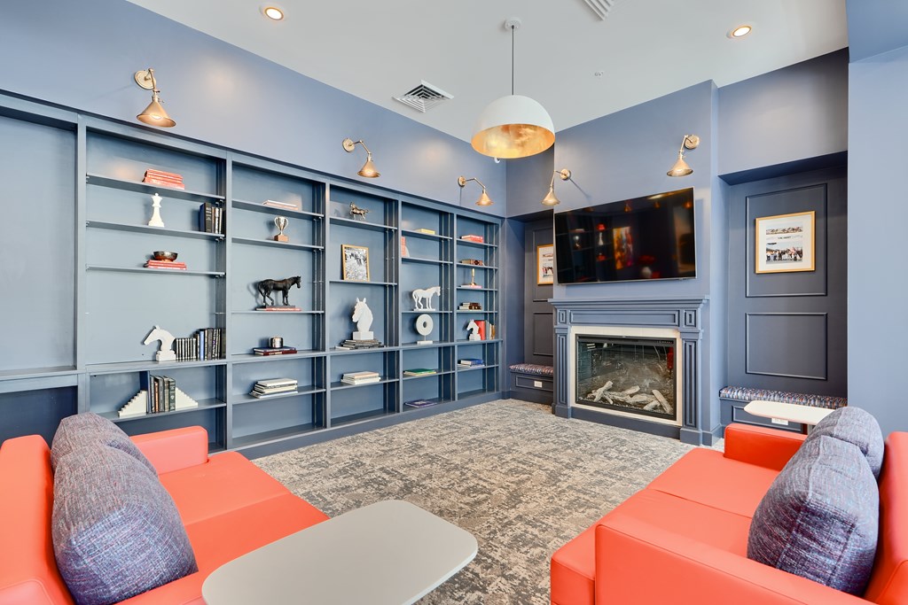 Now leasing senior 1-bedrooms in Baltimore, MD. A living room with a fireplace and a television.