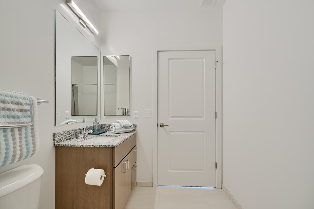 Now leasing senior 1-bedrooms in Baltimore, MD. A bathroom with a sink, mirror, and towel rack.