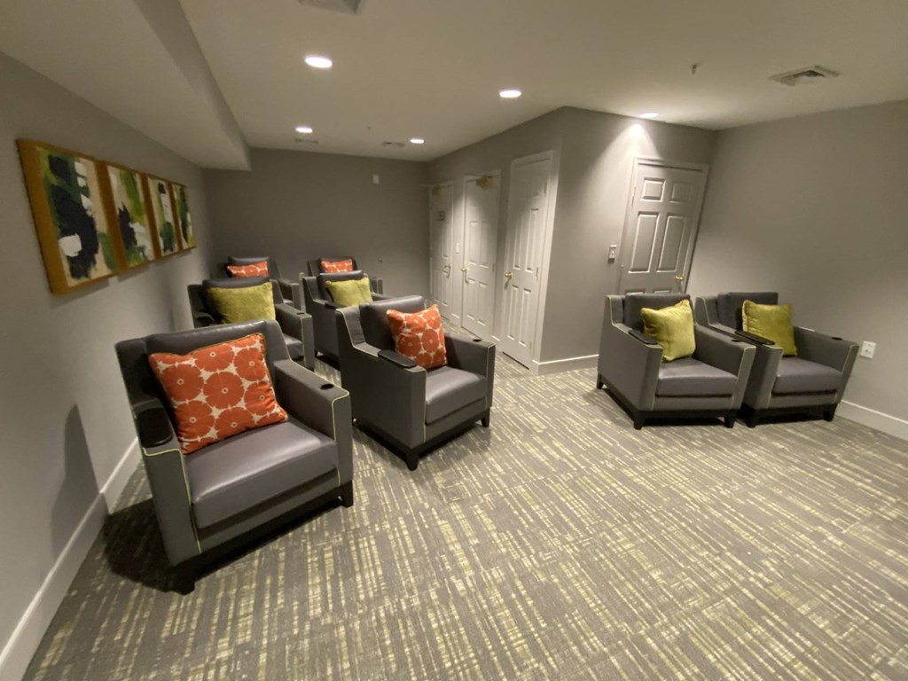 a common room with chairs and pillows