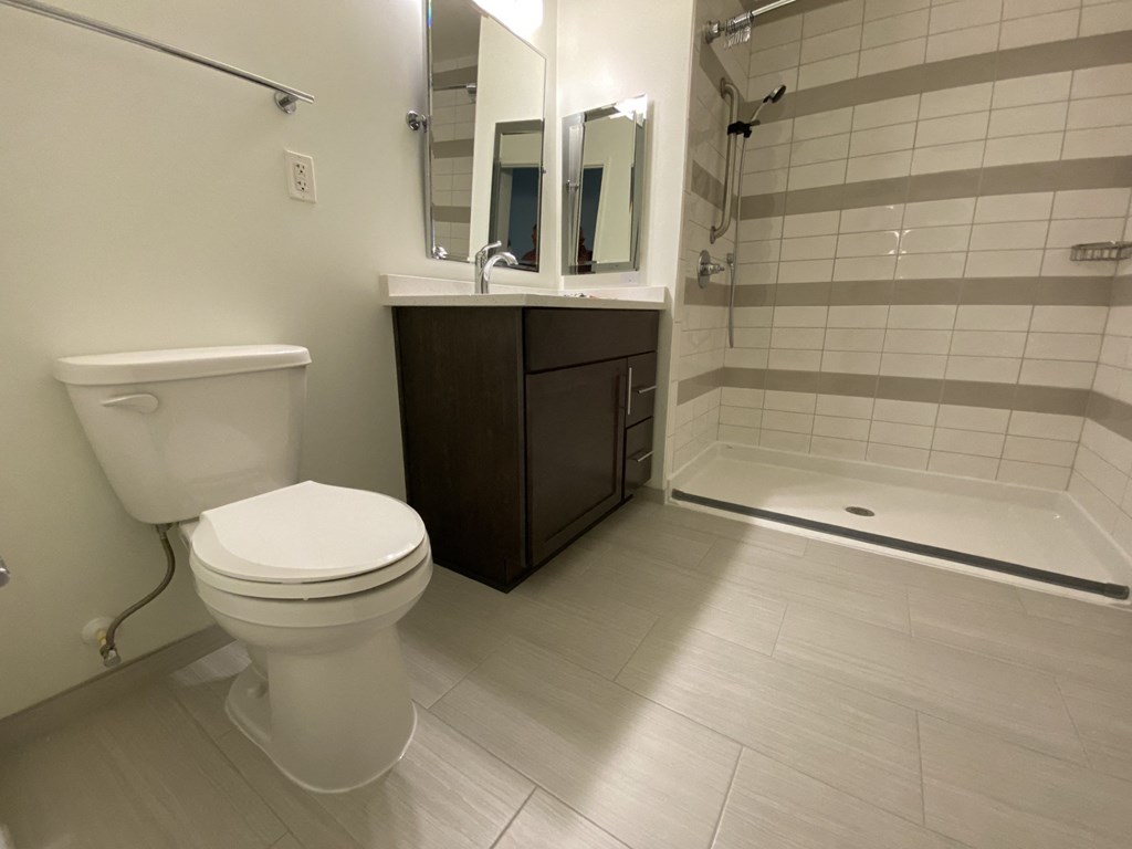 a bathroom with a toilet and a sink and a shower