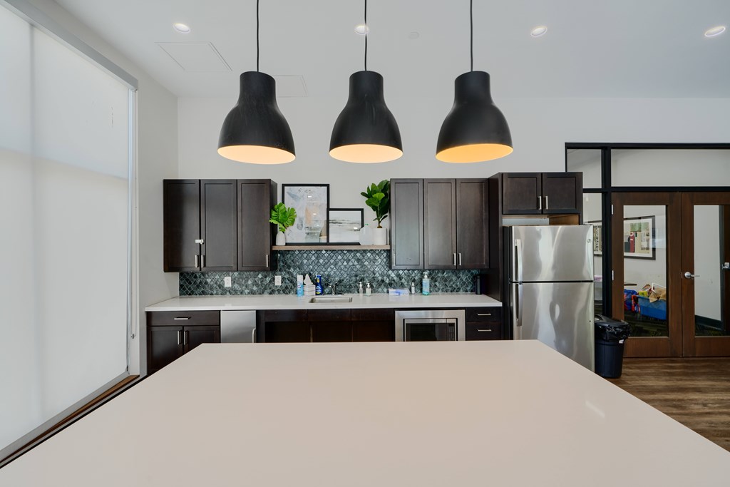 A modern kitchen with a large island in the foreground.