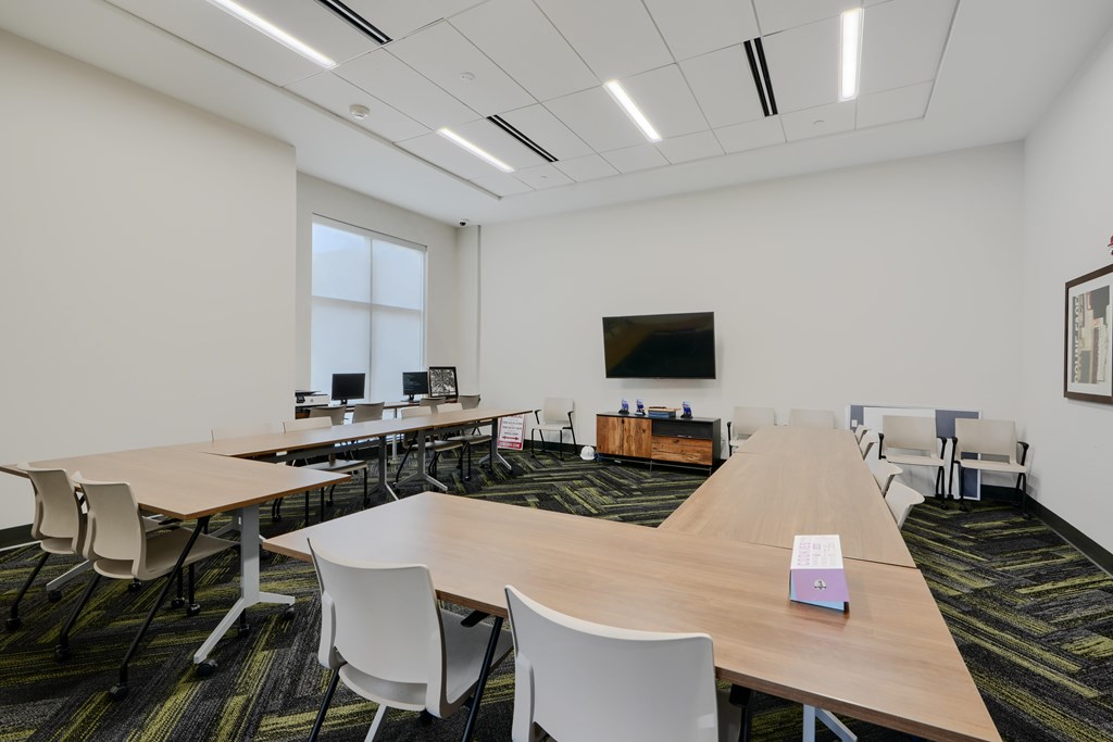A conference room with a long table and chairs.