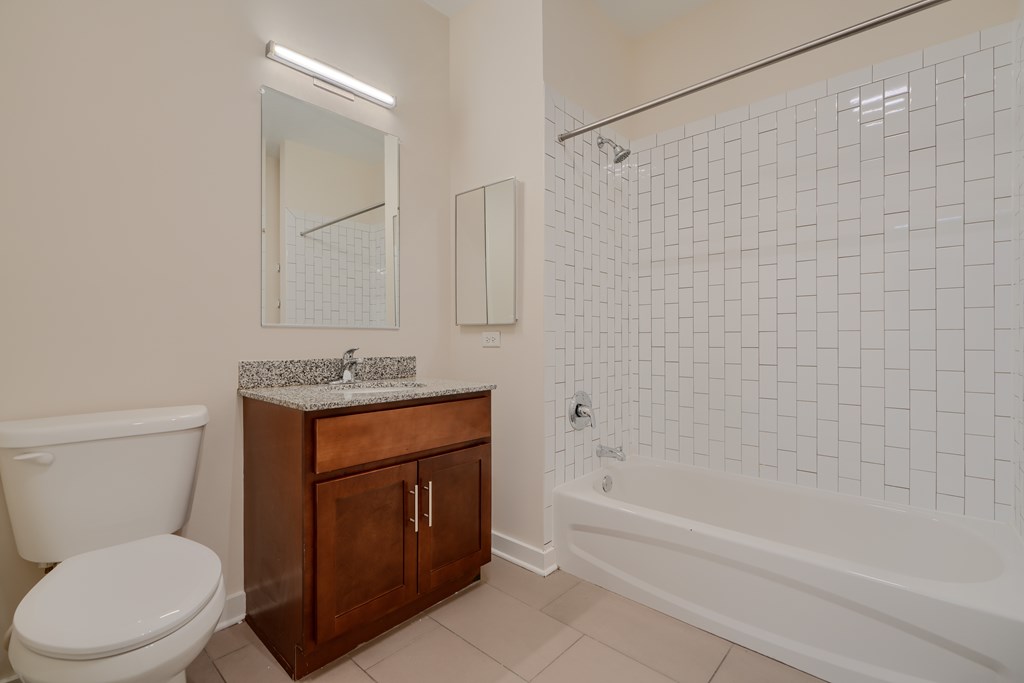 A white toilet sits next to a sink in a bathroom.