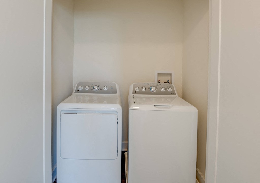 a washer and dryer in a laundry room with white appliances