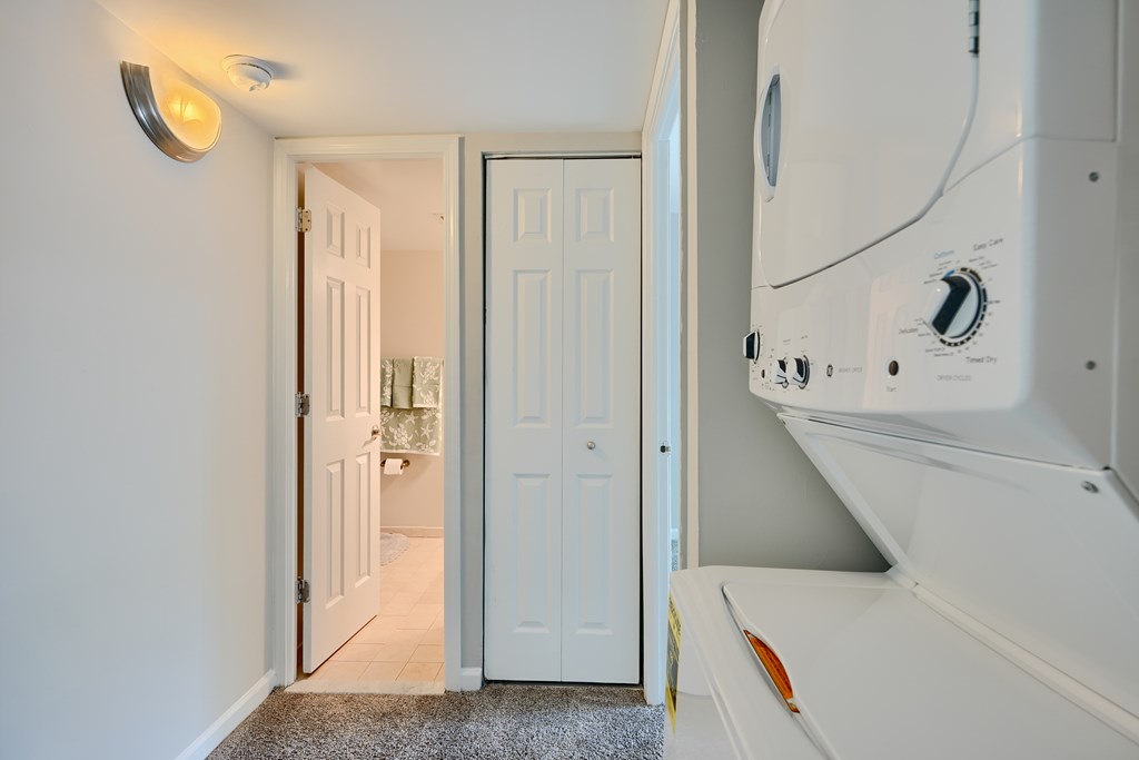 A white washing machine is in a laundry room.