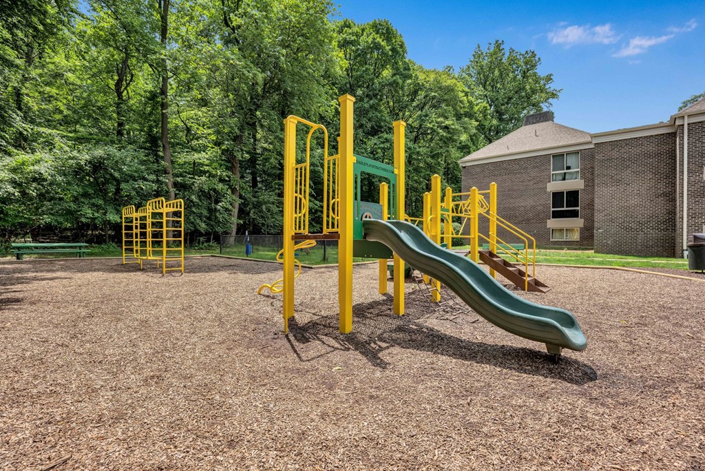 a playground with a slide and other playground equipment