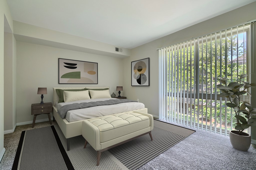 A bedroom with a large bed and a potted plant.