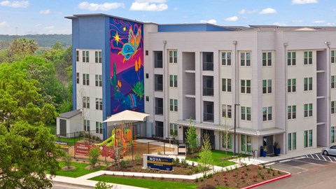 Modern apartment community featuring contemporary architecture, beautifully maintained landscaping, and inviting curb appeal.