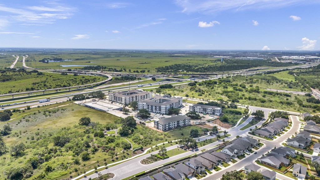 an aerial view of a city with buildings and highways