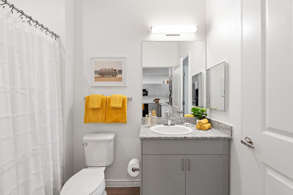 a bathroom with a shower and a sink and a toilet