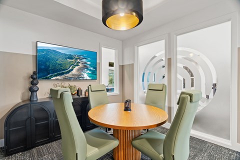 Work-from-home amenity space featuring computer stations, collaborative work areas, and modern business center amenities.