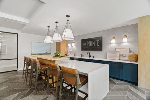A kitchen with a dining table and chairs.