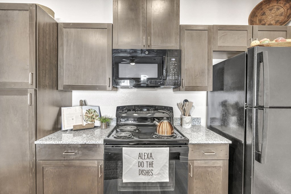 a kitchen with stainless steel appliances and granite counter tops