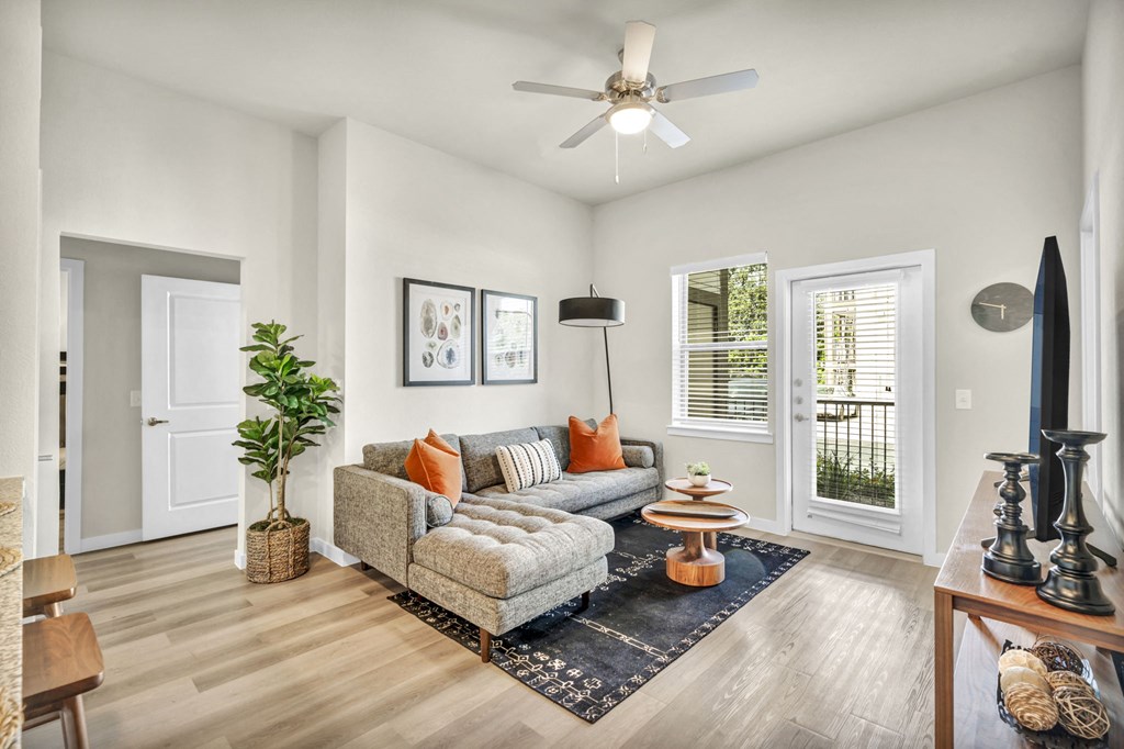 a living room with a couch and a ceiling fan