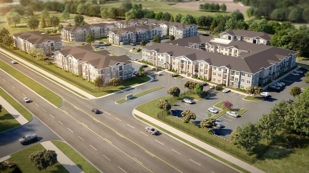 A road with cars and apartment buildings on the side.