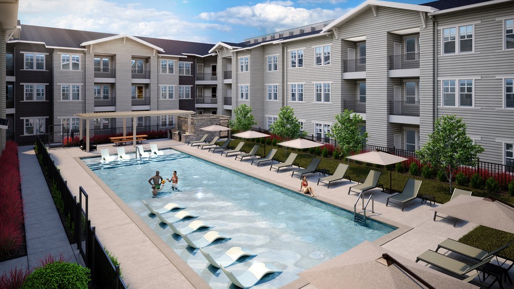 A swimming pool with people in it and chairs around it.