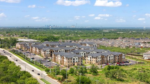 A suburban area with apartment buildings and a highway.