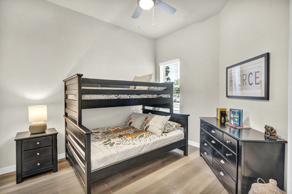 a bedroom with a bunk bed and a dresser