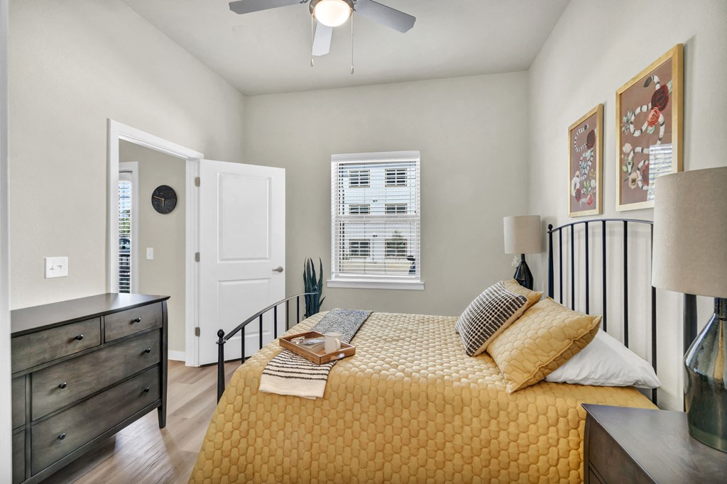 a bedroom with a bed and a ceiling fan