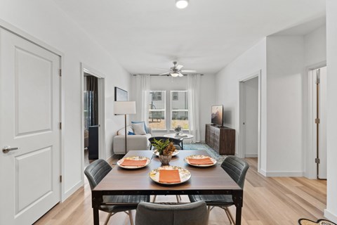 Modern apartment dining room at The Esther apartments with dining table and chairs.