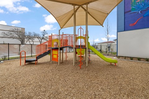 Community playground featuring modern play equipment, slides, and a welcoming outdoor space for recreation and exploration.
