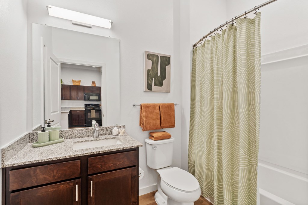 A bathroom with a toilet, sink, and shower.
