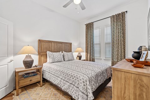 Bedroom at Aviator 1518 with bed, dresser and nightstands in an open floor plan layout.