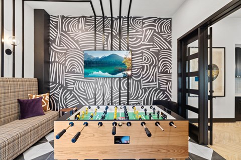 a room with a foosball table and a couch