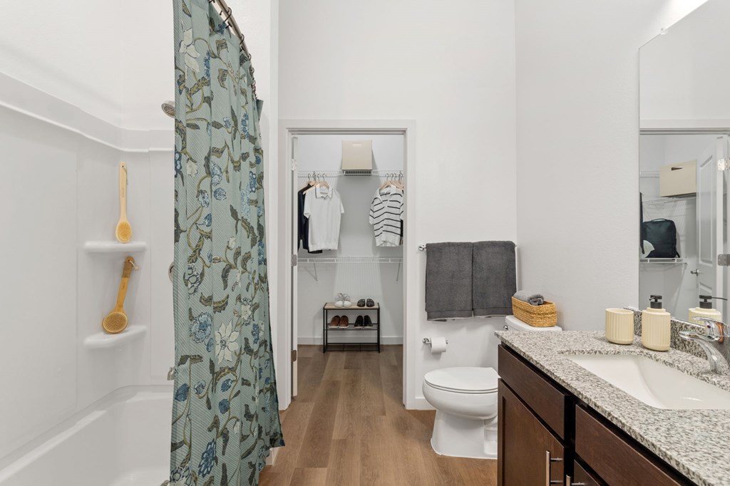 A bathroom with a toilet, sink, and shower.