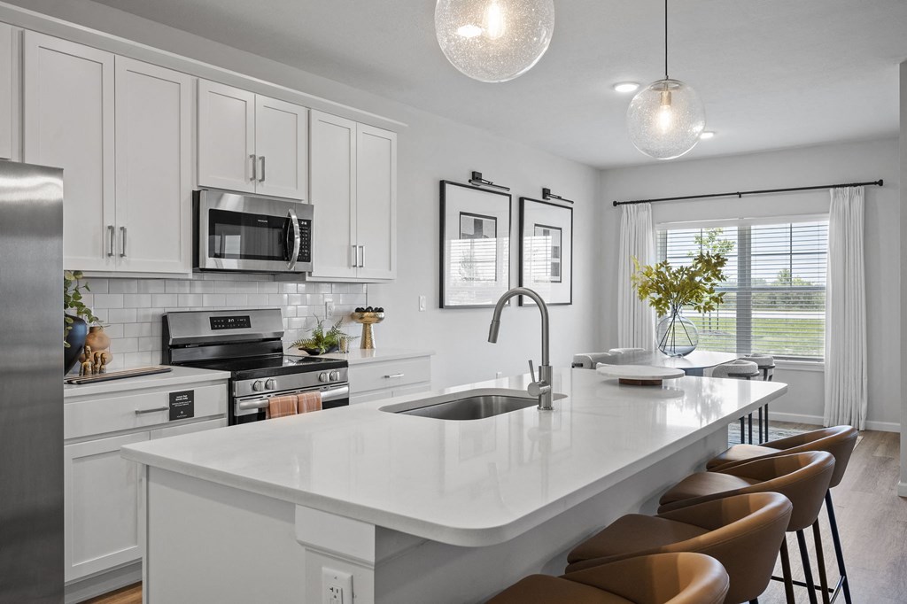 an open kitchen with a large counter top and a sink