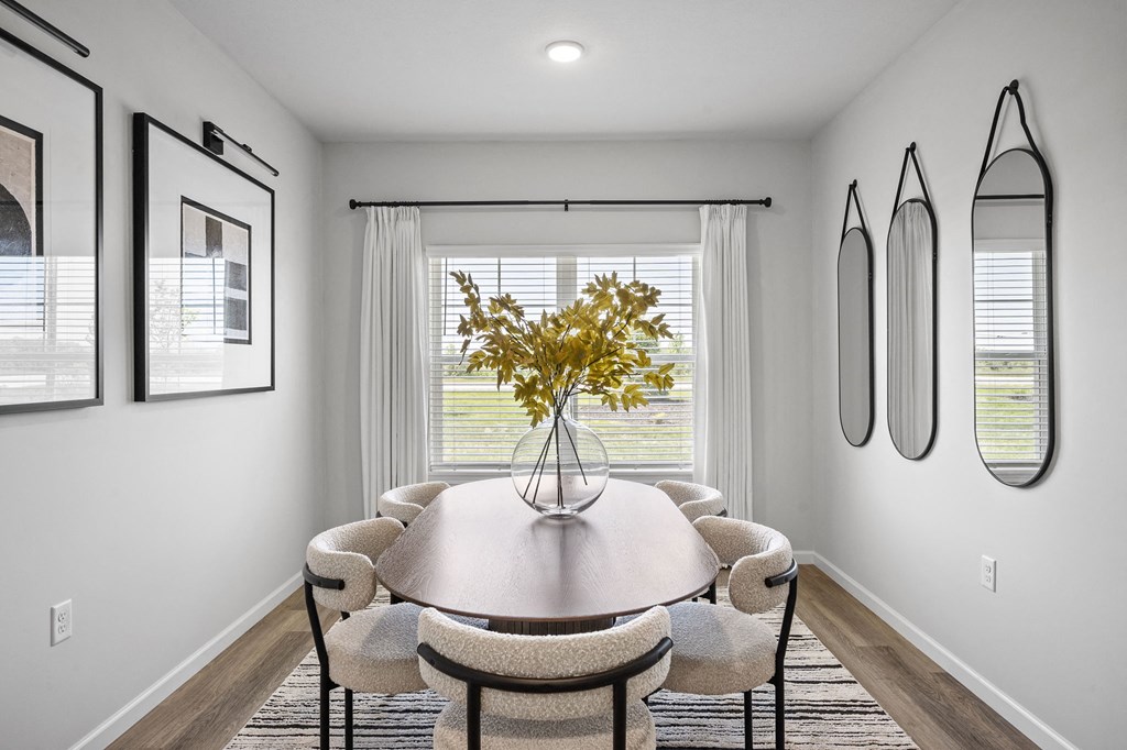 a dining room with a table and chairs and a window