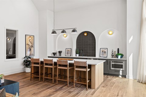 A modern kitchen with a wooden table and chairs.