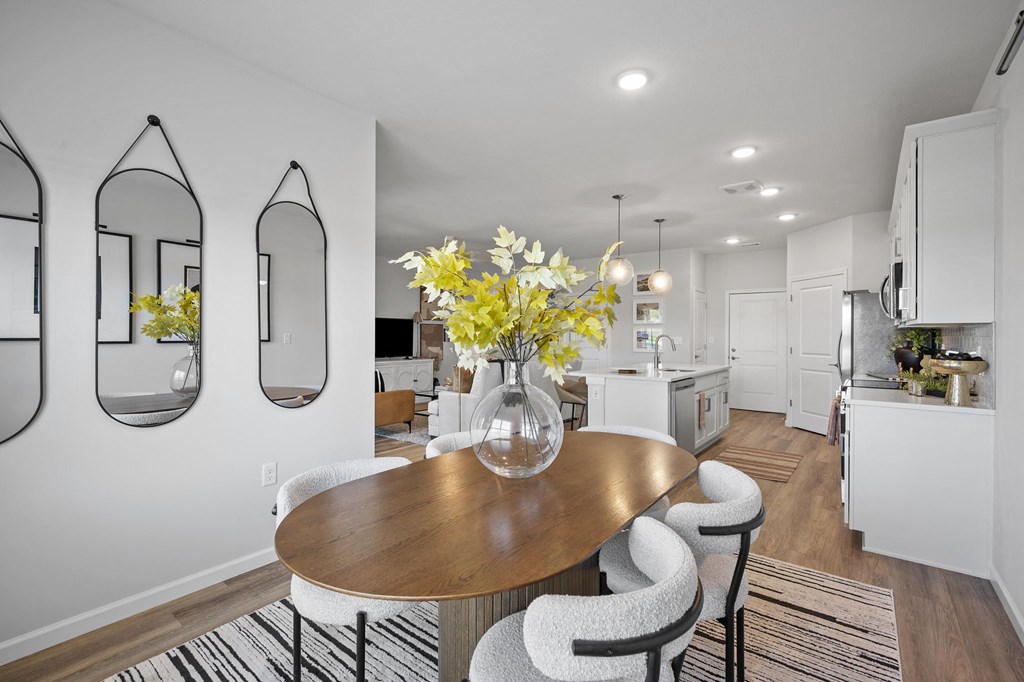 a dining room with a table and chairs