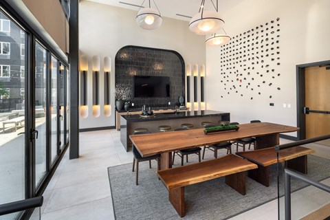 A modern kitchen with a wooden table and chairs.