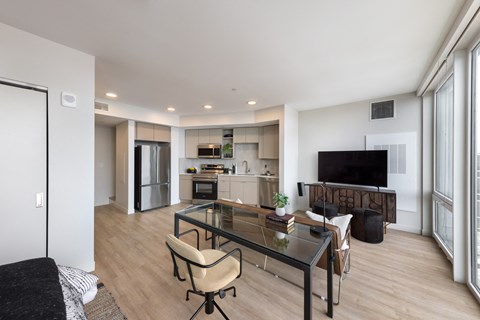 A modern living room with a glass table and a television.