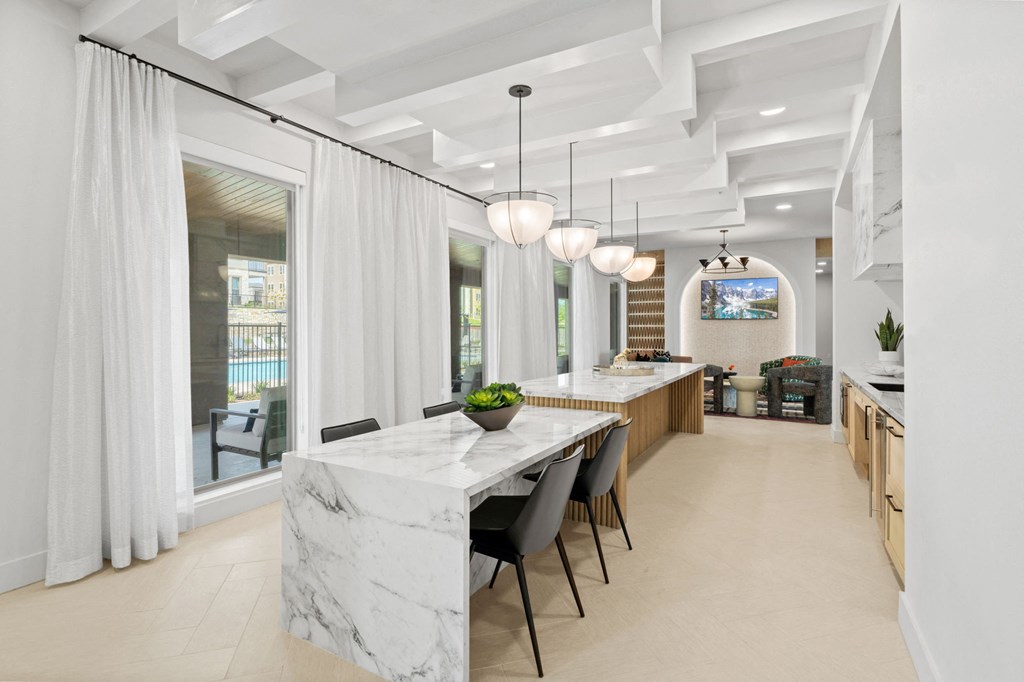a long counter top and a long table with chairs
